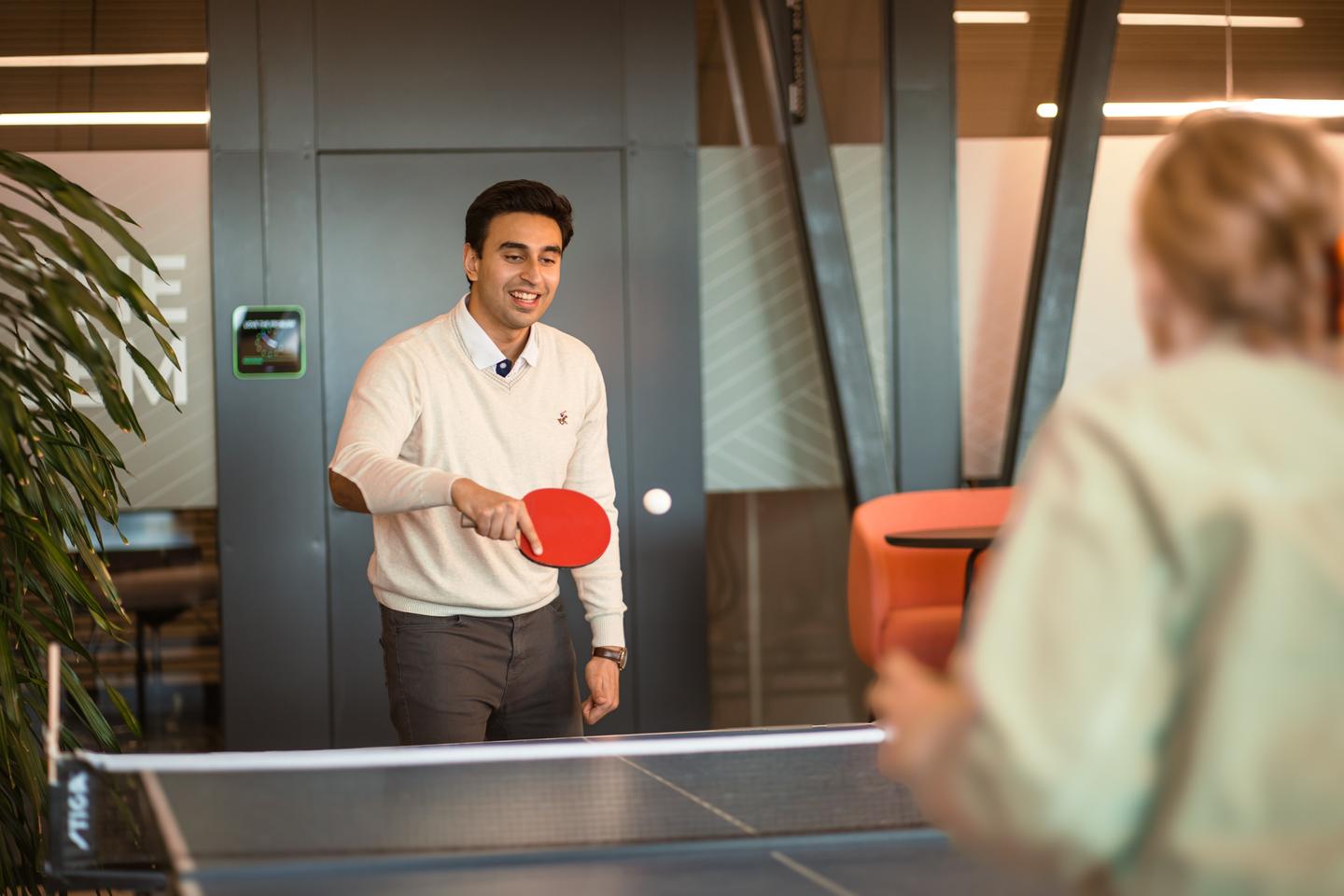 Irtaza Hashmi playing table tennis at Futurice office