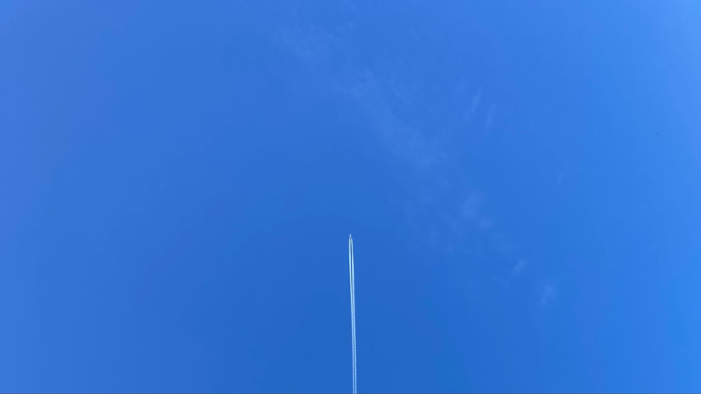 A plane going straight up into the sky.