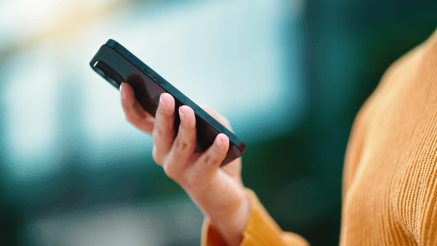 A person holding up a mobile phone