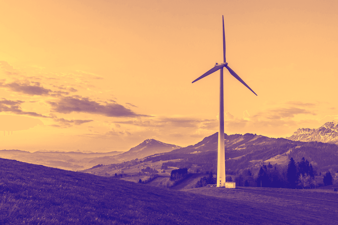 Image of a wind turbine on mountain range